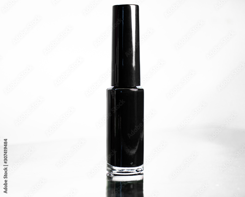 Bottle with black nail polish close-up on a white background Bottle with black nail polish close-up on a white background