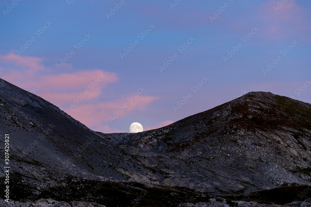 Moonrise over the Majestic Mountains at Dusk