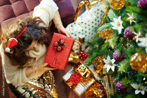 elegant 40 year old housewife holding Christmas present box photo