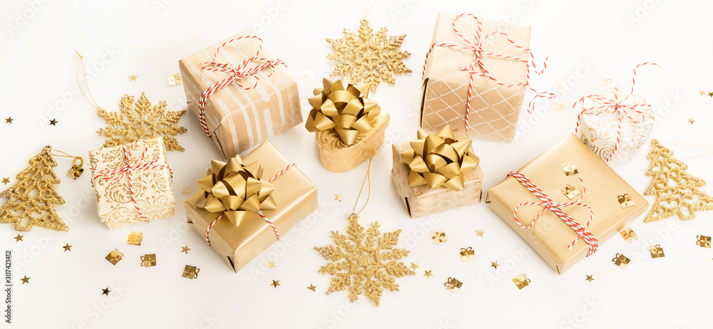 Gift or present boxes and stars confetti on white table top view. Flat lay composition for birthday, christmas or wedding. Gift or present boxes and stars confetti on white table top view. Flat lay composition for birthday, christmas or wedding.