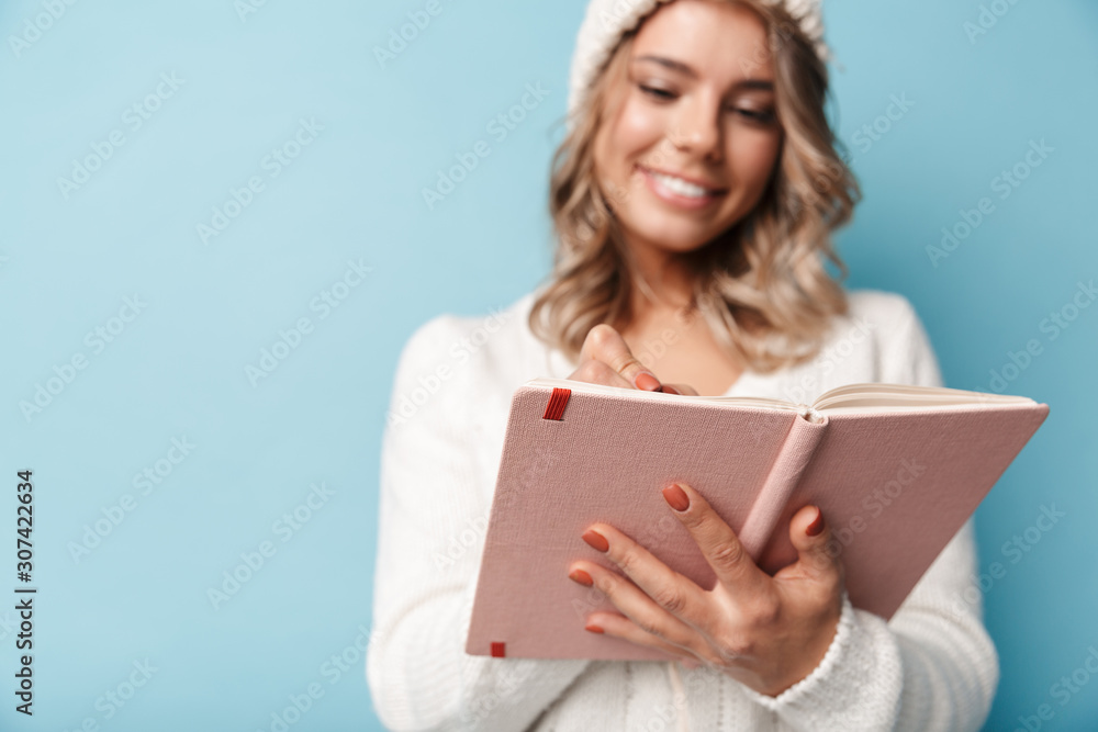 Portrait of young smiling woman making notes in diary Portrait of young smiling woman making notes in diary