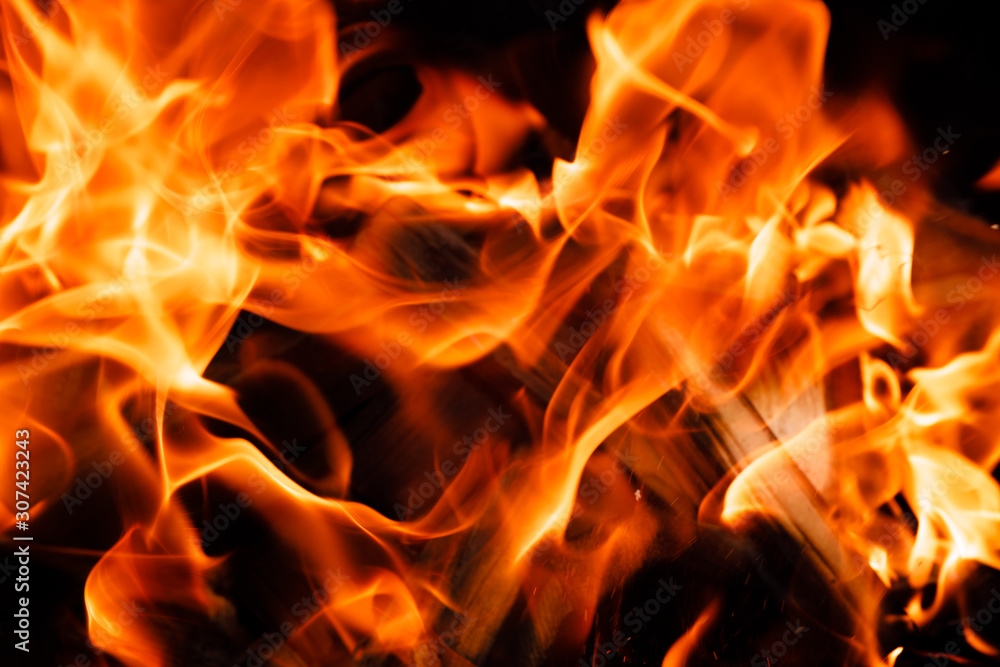 Texture of a flame of fire on a black background. burning fire in a stove closeup Texture of a flame of fire on a black background. burning fire in a stove closeup