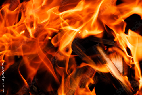 Texture of a flame of fire on a black background. burning fire in a stove closeup