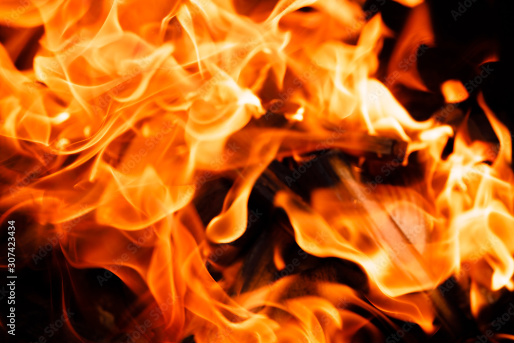 Texture of a flame of fire on a black background. burning fire in a stove closeup Texture of a flame of fire on a black background. burning fire in a stove closeup