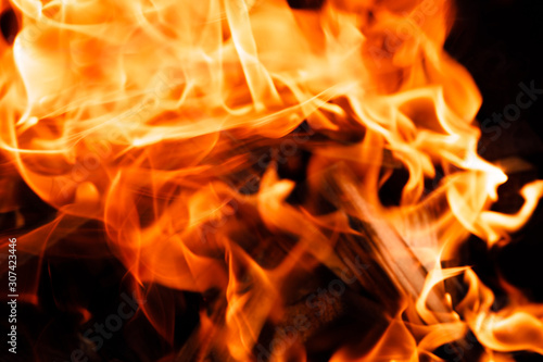 Texture of a flame of fire on a black background. burning fire in a stove closeup