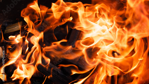 Texture of a flame of fire on a black background. burning fire in a stove closeup