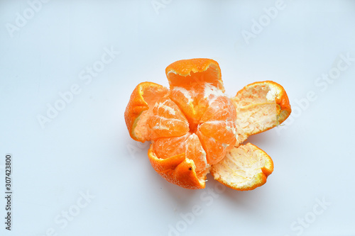 peeled tangerine on a white background.Orange fruits and peeled segment Isolated. Pile of orange segments