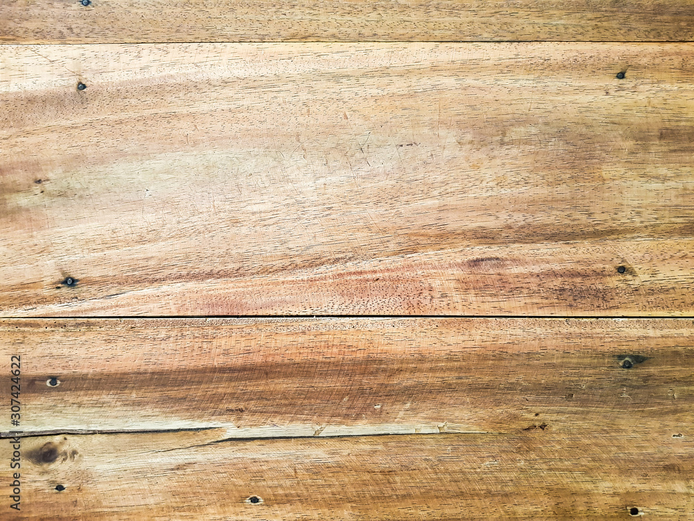 Fototapeta premium Top horizontal of light brown wood panel texture. Home furniture and natural design decoration. Wooden table top close up shot with copy space for text.