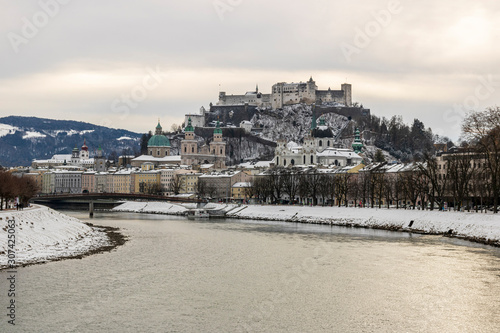Beautiful view of the historic city of Salzburg with Salzach river in winter during blue hour, Salzburger Land, Austria