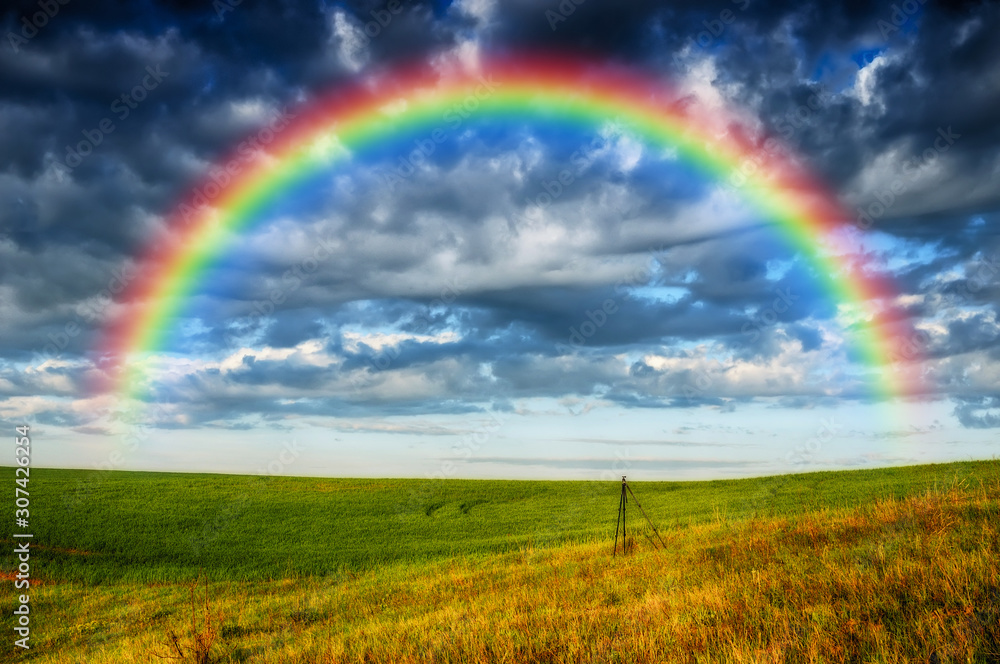 rainbow over the field. picturesque field rainbow over the field. picturesque field