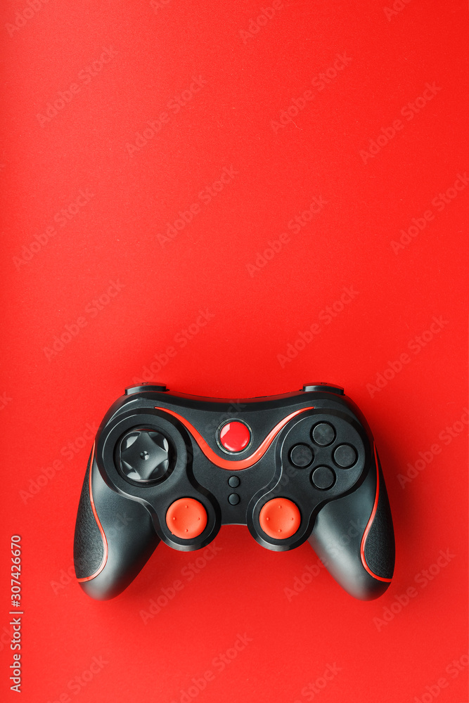 Game controller controller on red background. Device to control and control the game. Game controller controller on red background. Device to control and control the game.