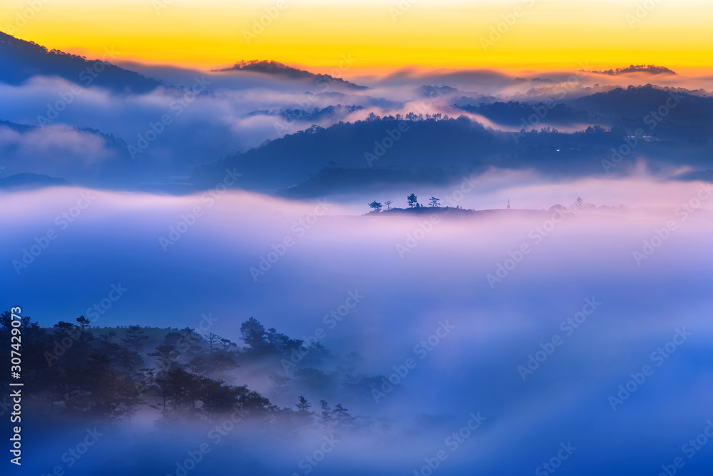 Dreamy scenery of mountains in misty sunset evening
