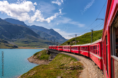 Rhaetian Railway, Bernina Express at Lago Bianco lake, Bernina Pass, Pontresina, Canton of Graubünden, Switzerland photo