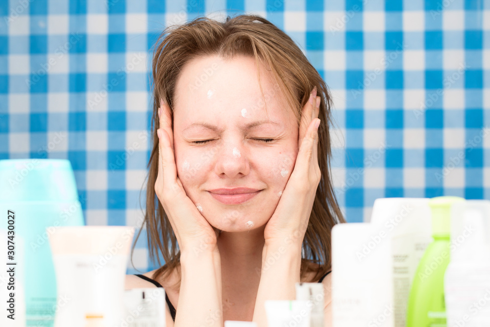 Portrait of cute girl with problem face skin in bathroom