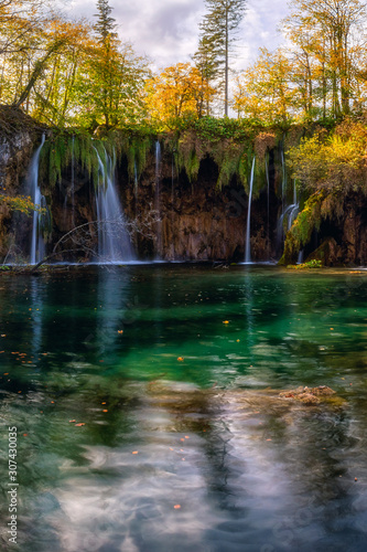 Plitvice lakes (Plitvicka jezera) national park, Croatia. Amazing autumn sunny landscape with waterfall Mali Buk, Gradinsko lake, colored trees and sky. Outdoor travel background, famous landmark © larauhryn