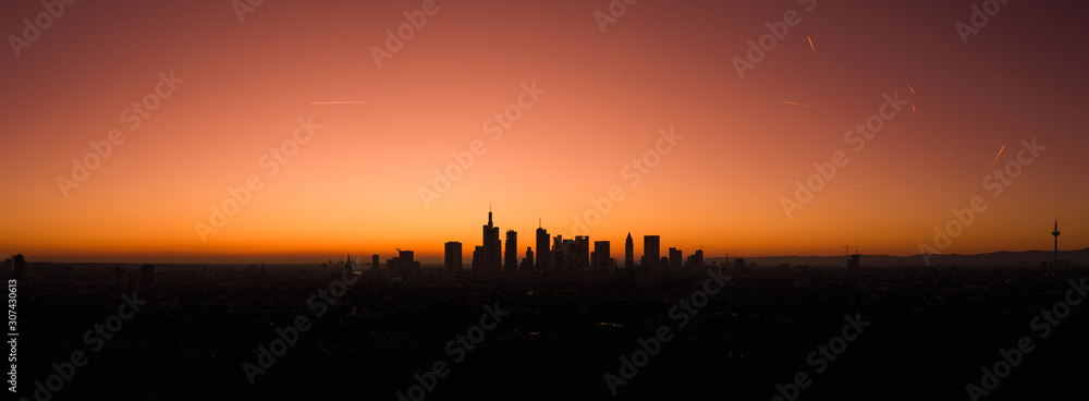 Aerial view with the silhouette drone in Frankfurt am Main at sunset in winter.