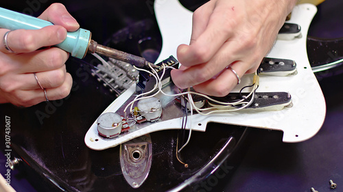 Repairing the interior electrical parts of a guitar