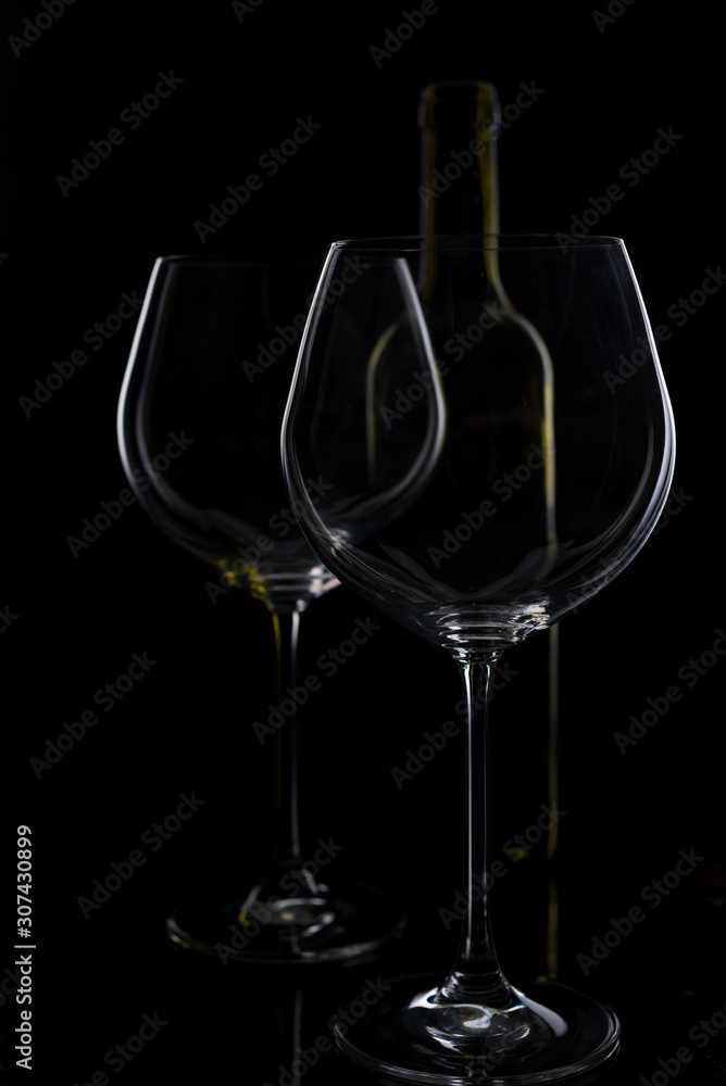 glass of red and pink wine on a black background. Wine list menu. Close up of the power of glasses and bottles in low key glass of red and pink wine on a black background. Wine list menu. Close up of the power of glasses and bottles in low key