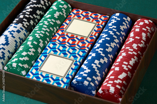 Poker set case on green texture background. Poker cards and chips