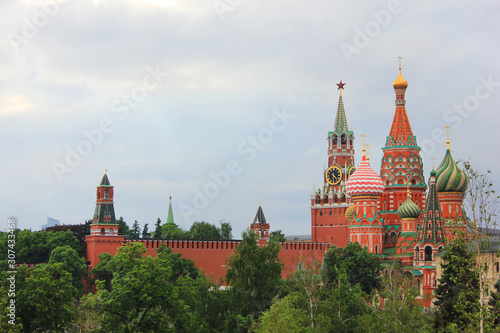Moscow Kremlin tower and Saint Basil's cathedral on the Red Square in cental Moscow, Russia. Scenic russian capital architecture view, historical old city buildings on cloudy summer day 