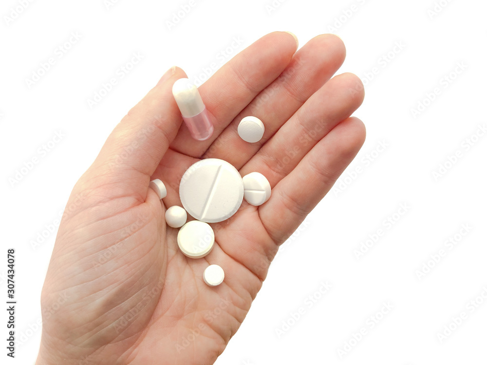 Hand with pills isolated on white background. Composition of pills and hand. Hand with pills isolated on white background. Composition of pills and hand.