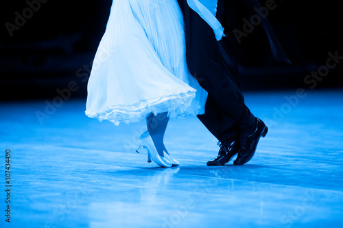 Woman and man dancer latino international dancing. Blue filter