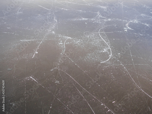 Texture of frozen ice on the lake with traces of skates