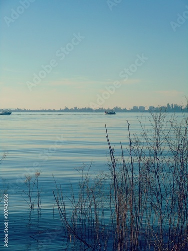 Looking at the sunrise. Water landscape. Blue sky