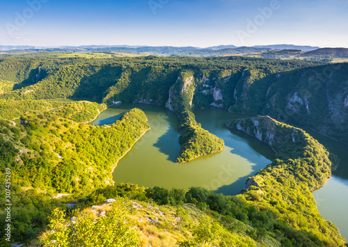 Green gorge in canyon of Uvac river in Serbia with sunset light photo