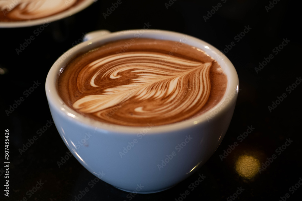 latte art, tulips on a white glass, black background latte art, tulips on a white glass, black background
