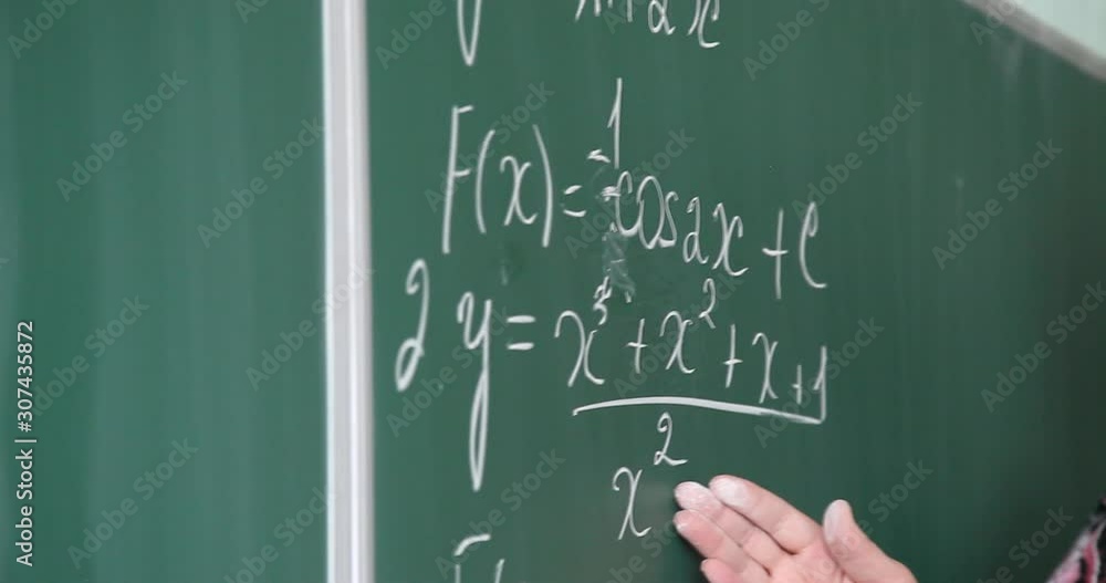 Concepts on blackboard at school. Young people, students and pupils in classroom. Smart hispanic girl writing math formula on board during lesson. Portrait of female child smiling, looking at camera Concepts on blackboard at school. Young people, students and pupils in classroom. Smart hispanic girl writing math formula on board during lesson. Portrait of female child smiling, looking at camera