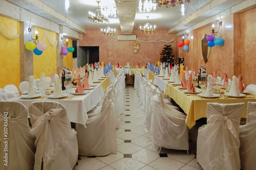 Banquet table in the large hall, served for the celebration of the New Year. Overal plan photo