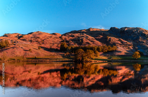 Rydal water lake in the Lake District, Cumbria, UK. Autumn reflections in the clear and still waters.