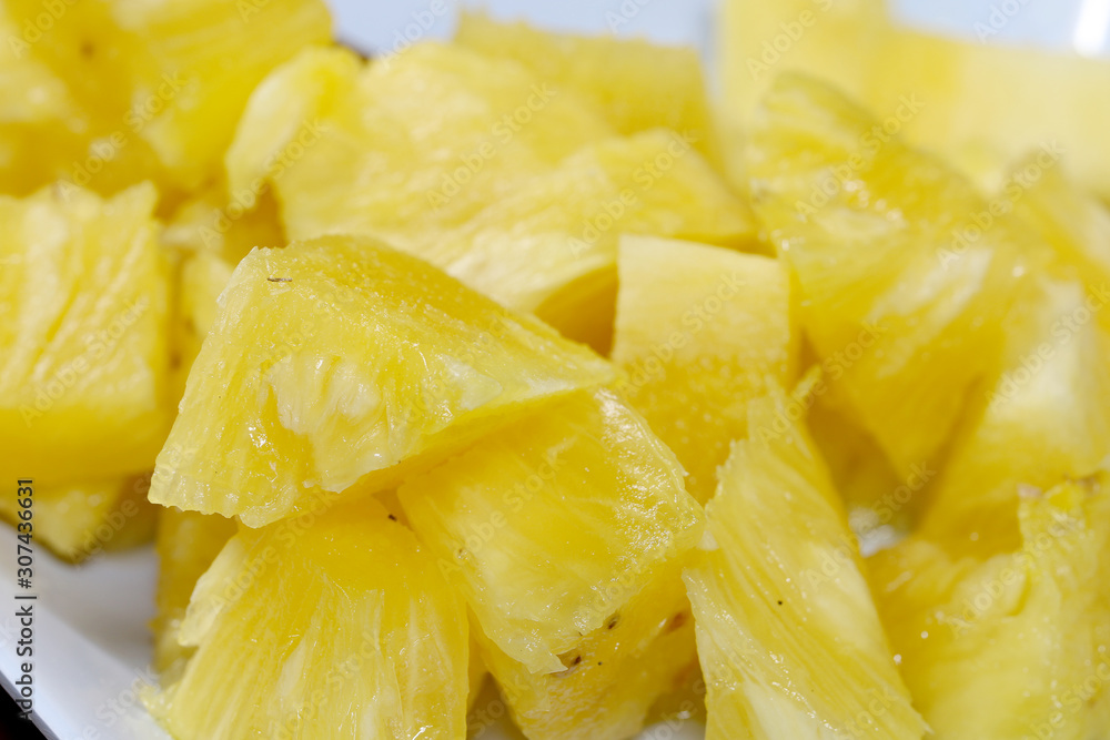 Close up slice pineapple background texture in white dish. Slide and piece of fresh fruit. Close up slice pineapple background texture in white dish. Slide and piece of fresh fruit.