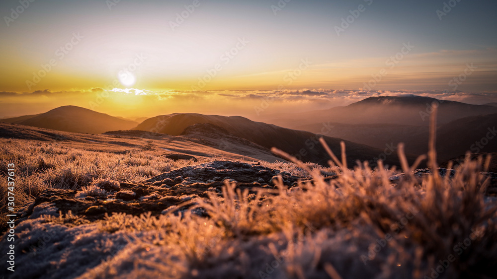 Sunrise on frozen mountains of Snowdonia National Park, Wales, UK