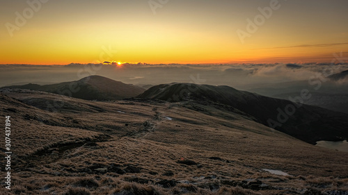 Sunrise on frozen mountains of Snowdonia National Park  Wales  UK