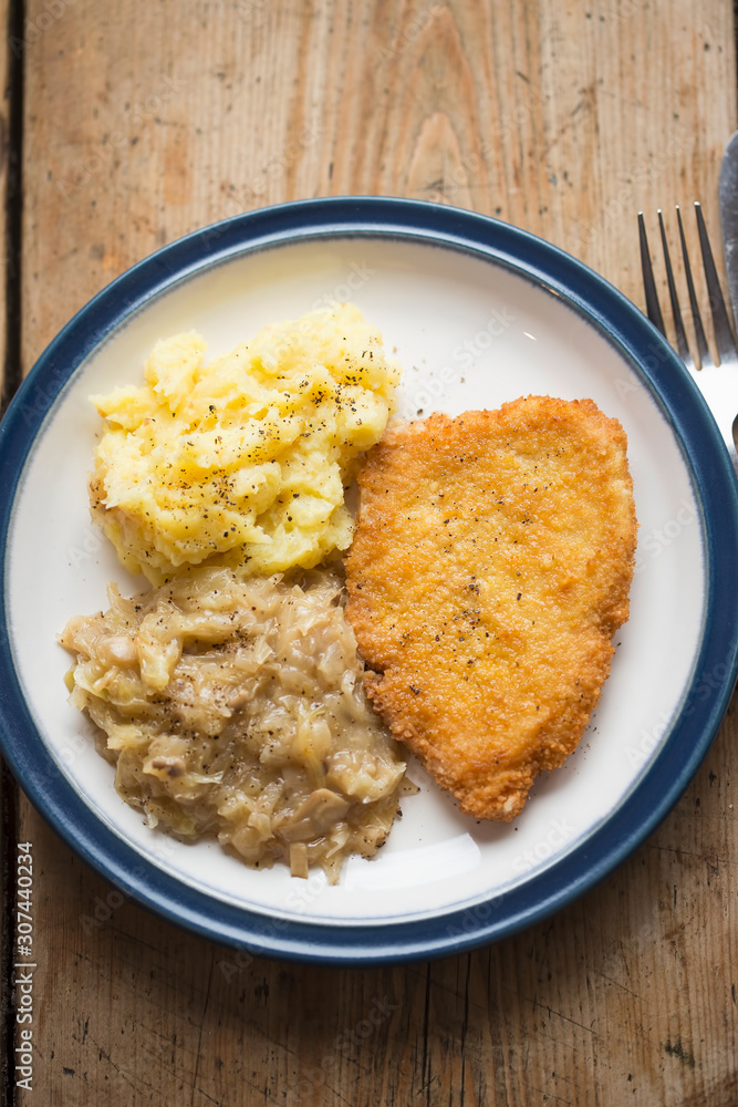 Breaded chicken breast with mashed potatoes and cabbage Breaded chicken breast with mashed potatoes and cabbage
