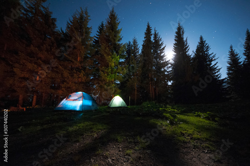 Tourist tents in forest at campsite.Night camping
