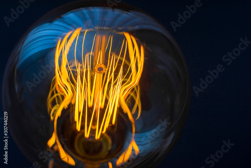Beautiful large round retro lamp with incandescent threads. Close-up. Creativity concept.