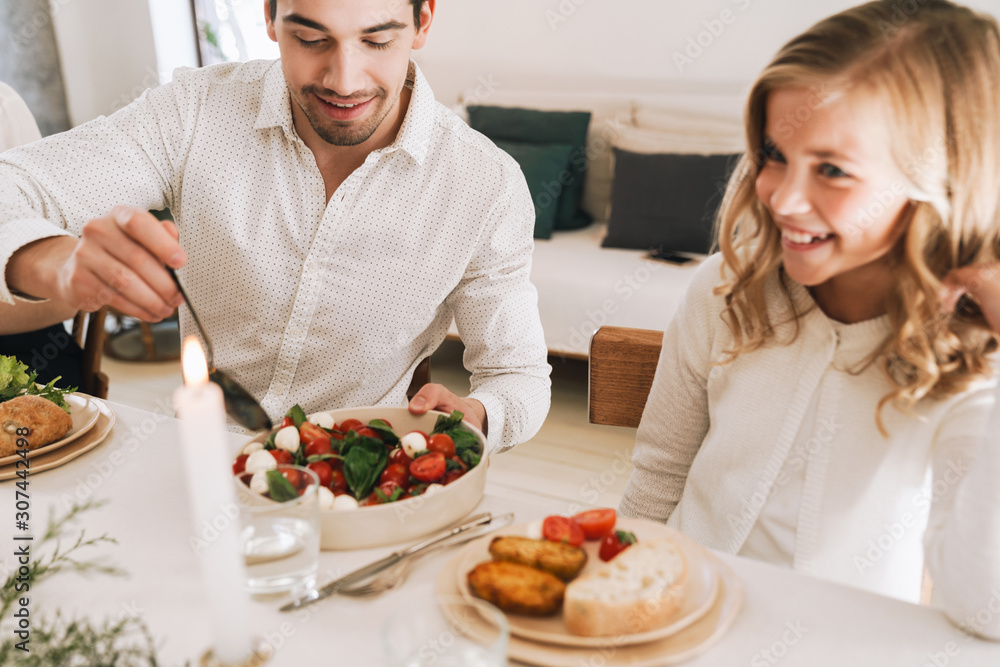 Happy father and his daughter having Christmas dinner