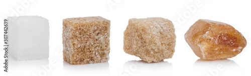 Cubes of natural brown and white and caramelized unrefined sugar cubes on white background. macro