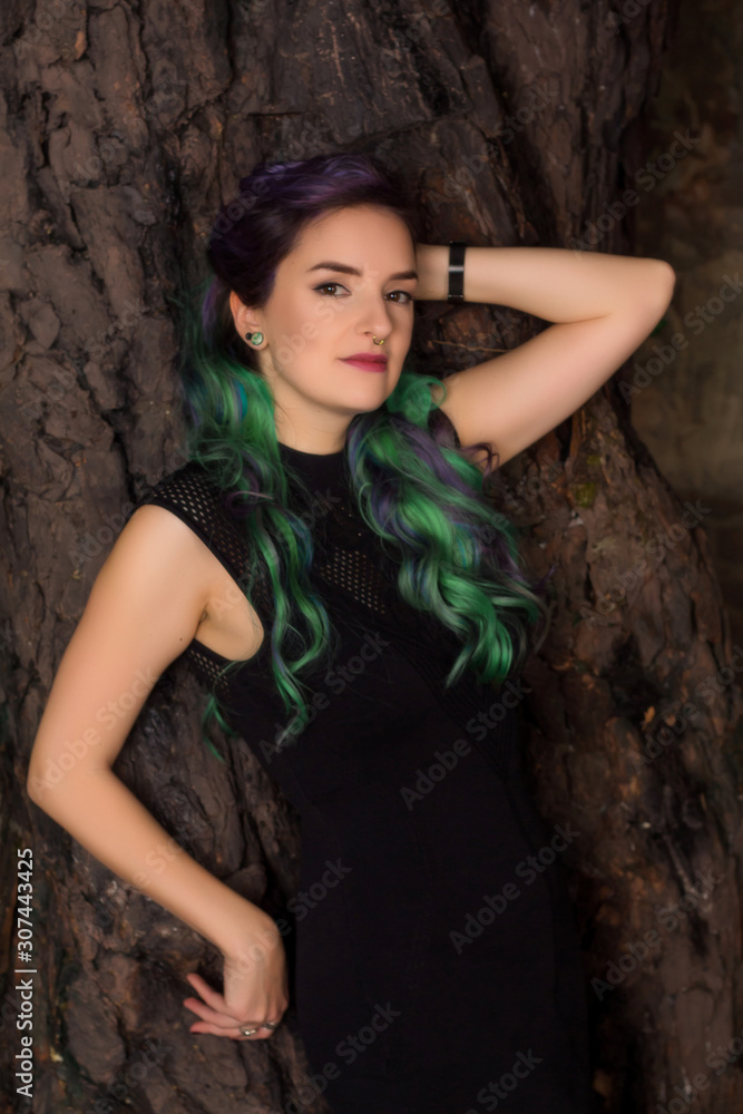 Naklejka premium portrait of young woman with colored hair