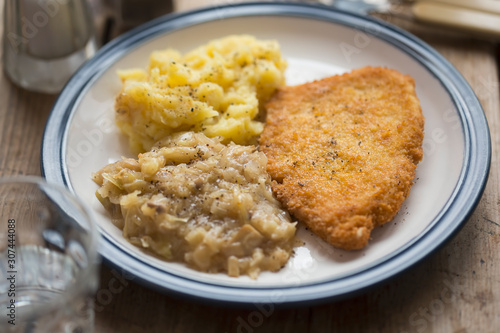 Breaded chicken breast with mashed potatoes and cabbage 