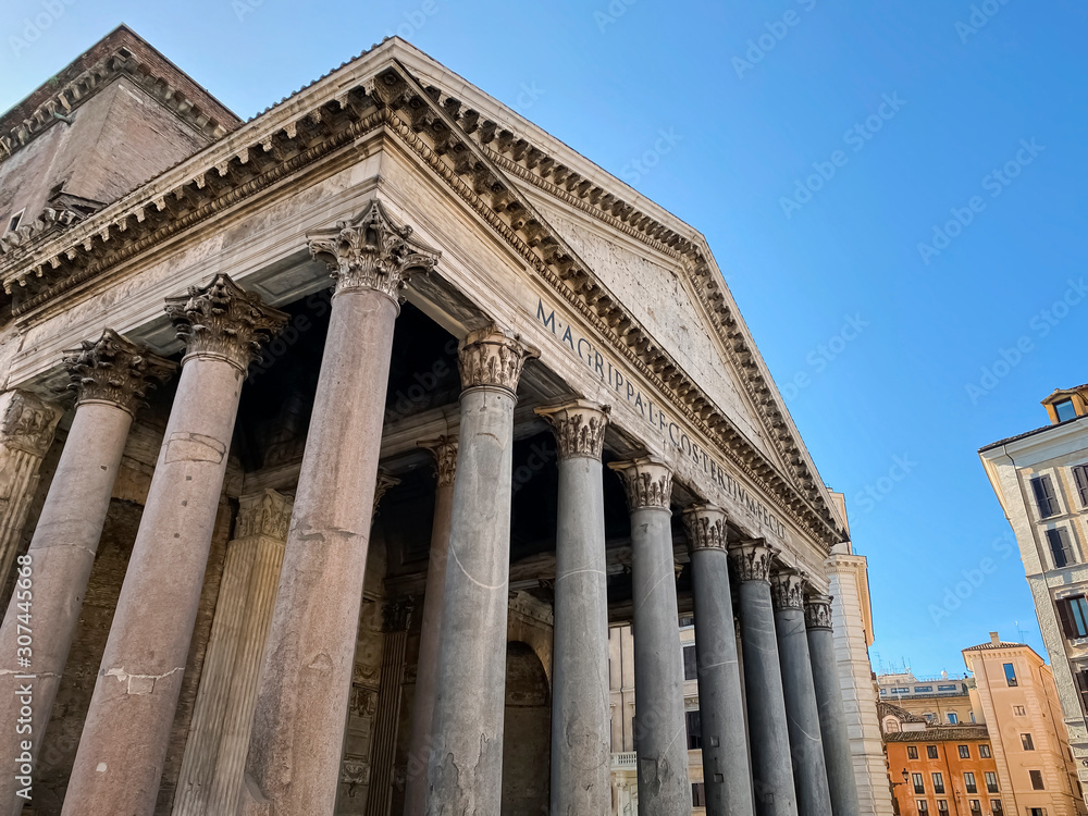 Wide angle shot of the facade with columns of the Pantheon in Rome.
