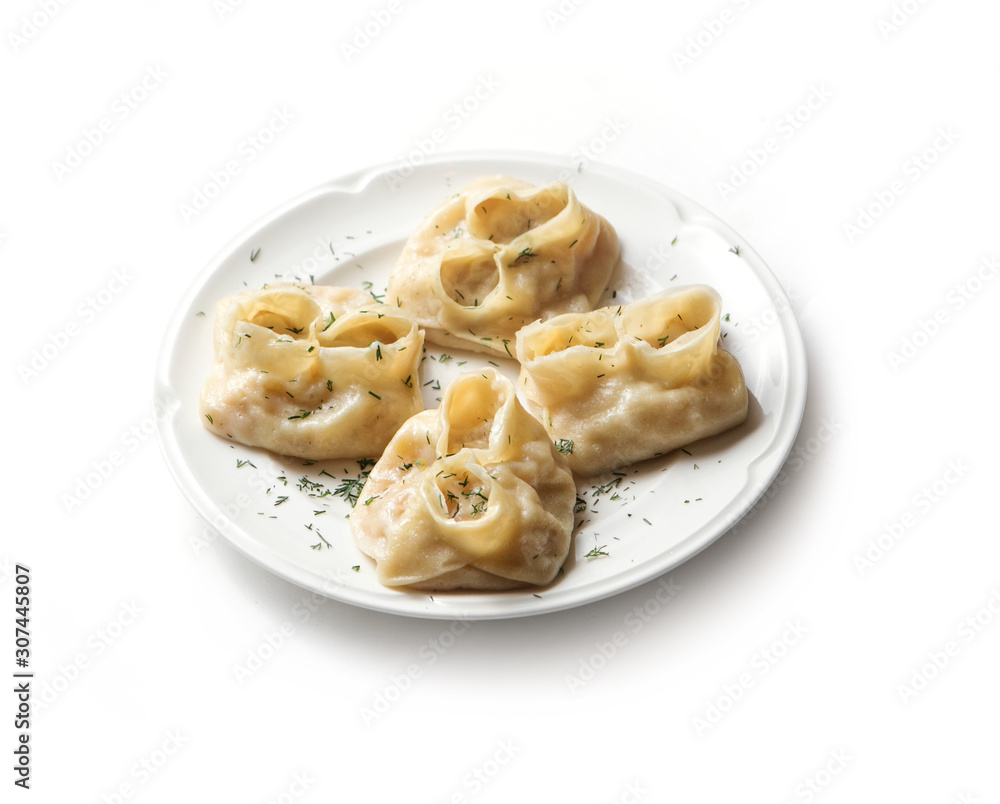 Traditional uzbek manti steamed with minced meat. Homemade manti on white plate.