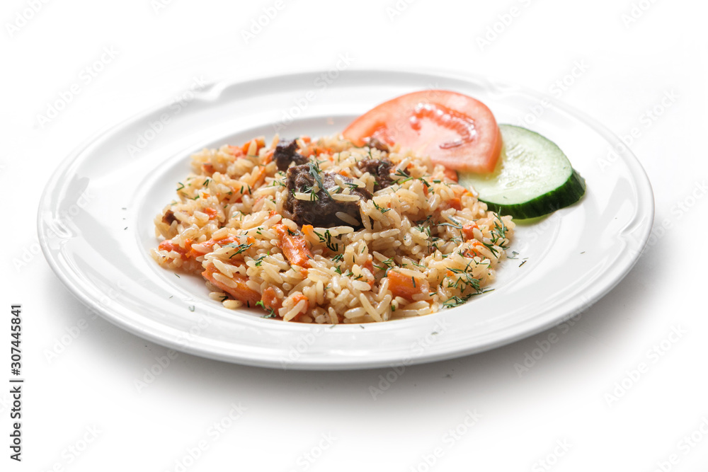 Traditional oriental pilaf with mutton, uzbek pilaf on a white plate on white background Traditional oriental pilaf with mutton, uzbek pilaf on a white plate on white background