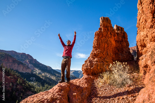 Quadro em tela Excited man celebrating hiking in the red rock formations of Southern Utah