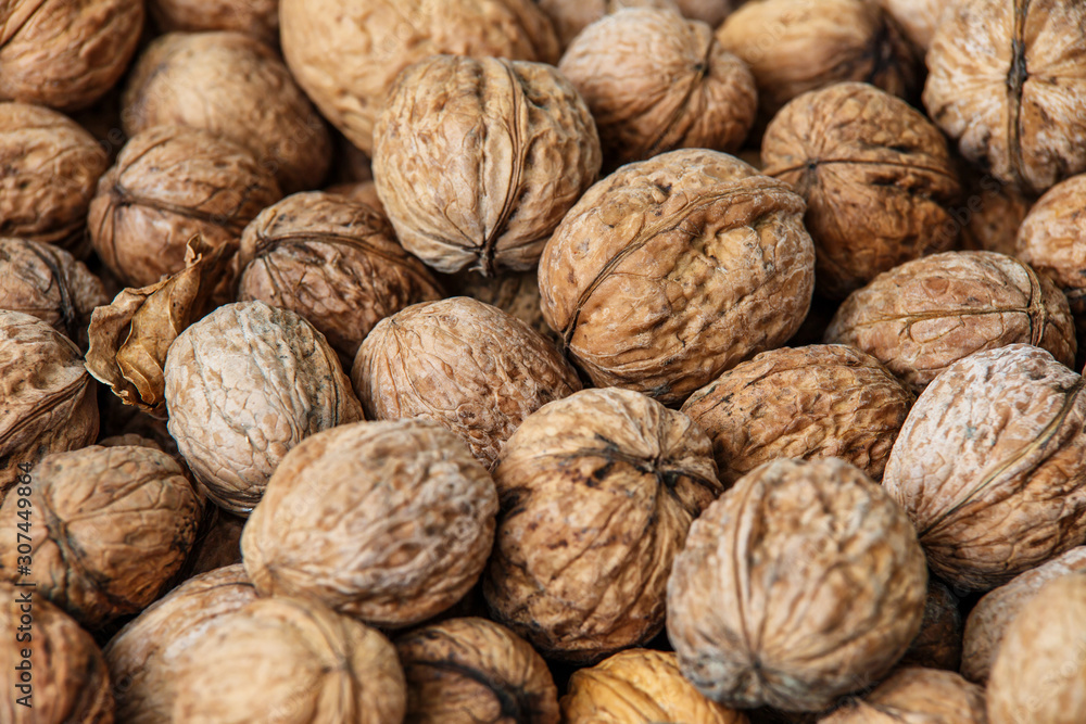 walnuts, unpeeled greek nuts, harvest of walnuts, walnuts closeup, background with walnuts,organic delicious nuts. healthy snack. walnuts, unpeeled greek nuts, harvest of walnuts, walnuts closeup, background with walnuts,organic delicious nuts. healthy snack.