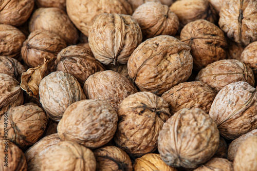 walnuts, unpeeled greek nuts, harvest of walnuts, walnuts closeup, background with walnuts,organic delicious nuts. healthy snack.