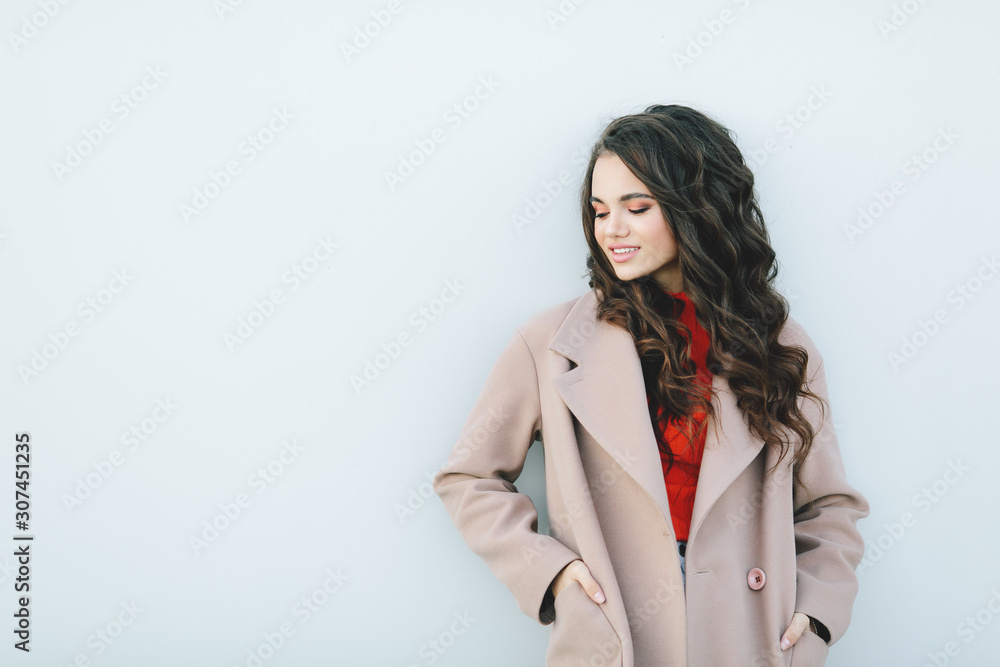 Hipster girl wearing orange t-shirt, jeans and coat posing against rough street wall, minimalist urban clothing style, mockup for tshirt print store Hipster girl wearing orange t-shirt, jeans and coat posing against rough street wall, minimalist urban clothing style, mockup for tshirt print store